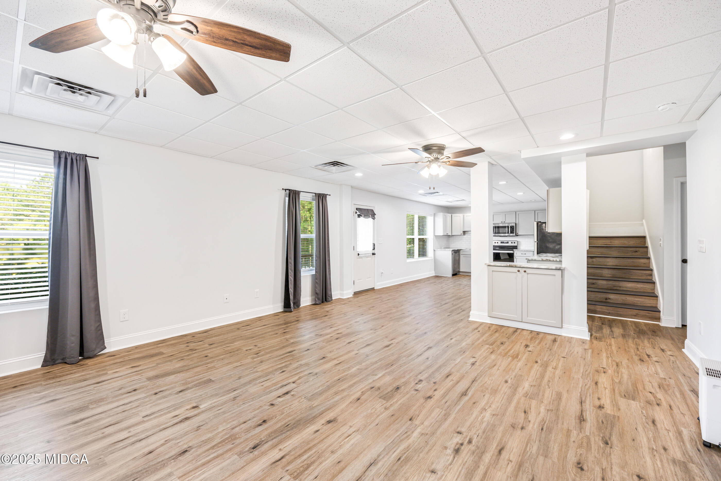 36 River Rapids Drive Forsyth, GA 31029 - Photo 33 of 57 a view of a kitchen with wooden floor and a ceiling fan