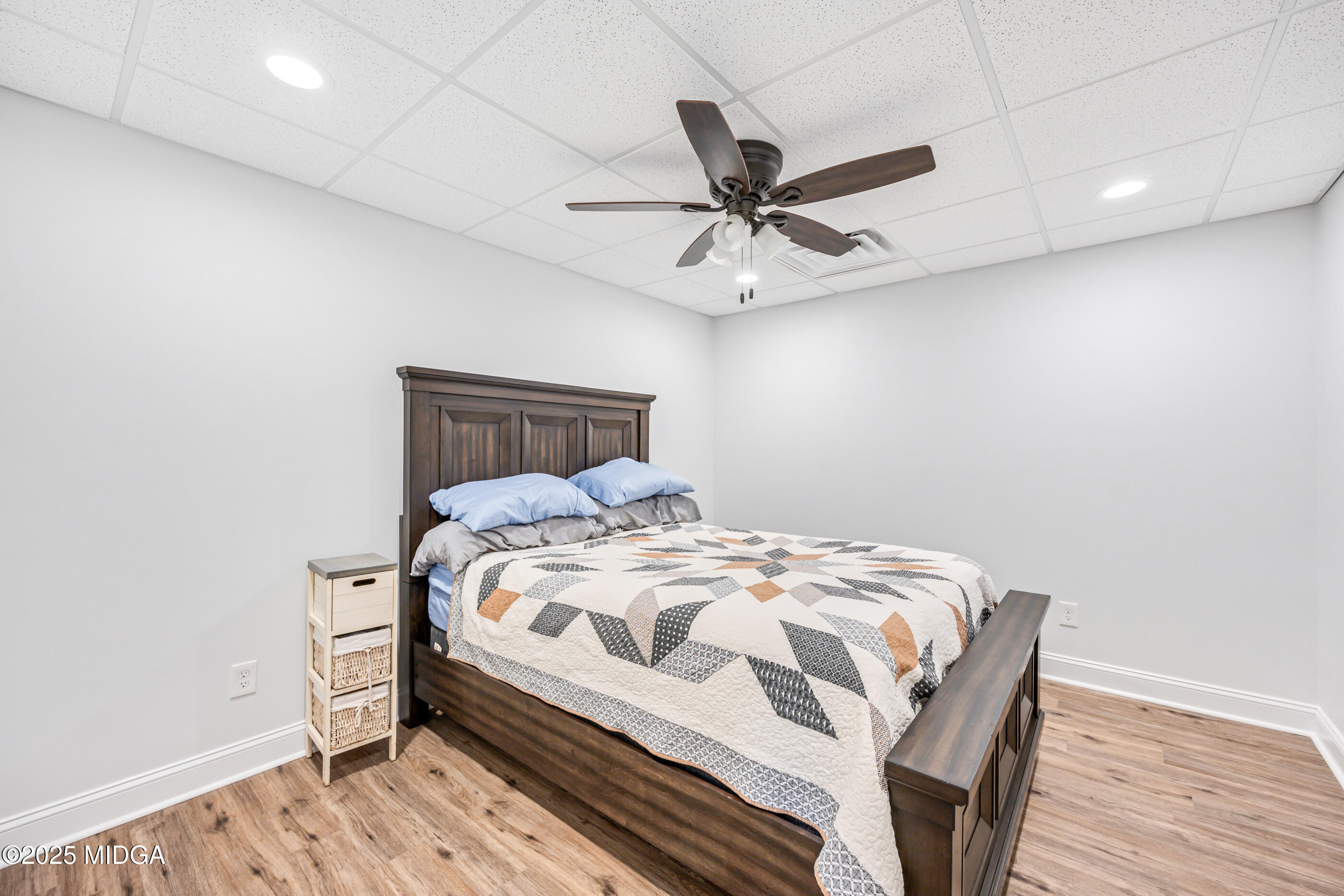 36 River Rapids Drive Forsyth, GA 31029 - Photo 34 of 57 a bedroom with a bed and wooden floor