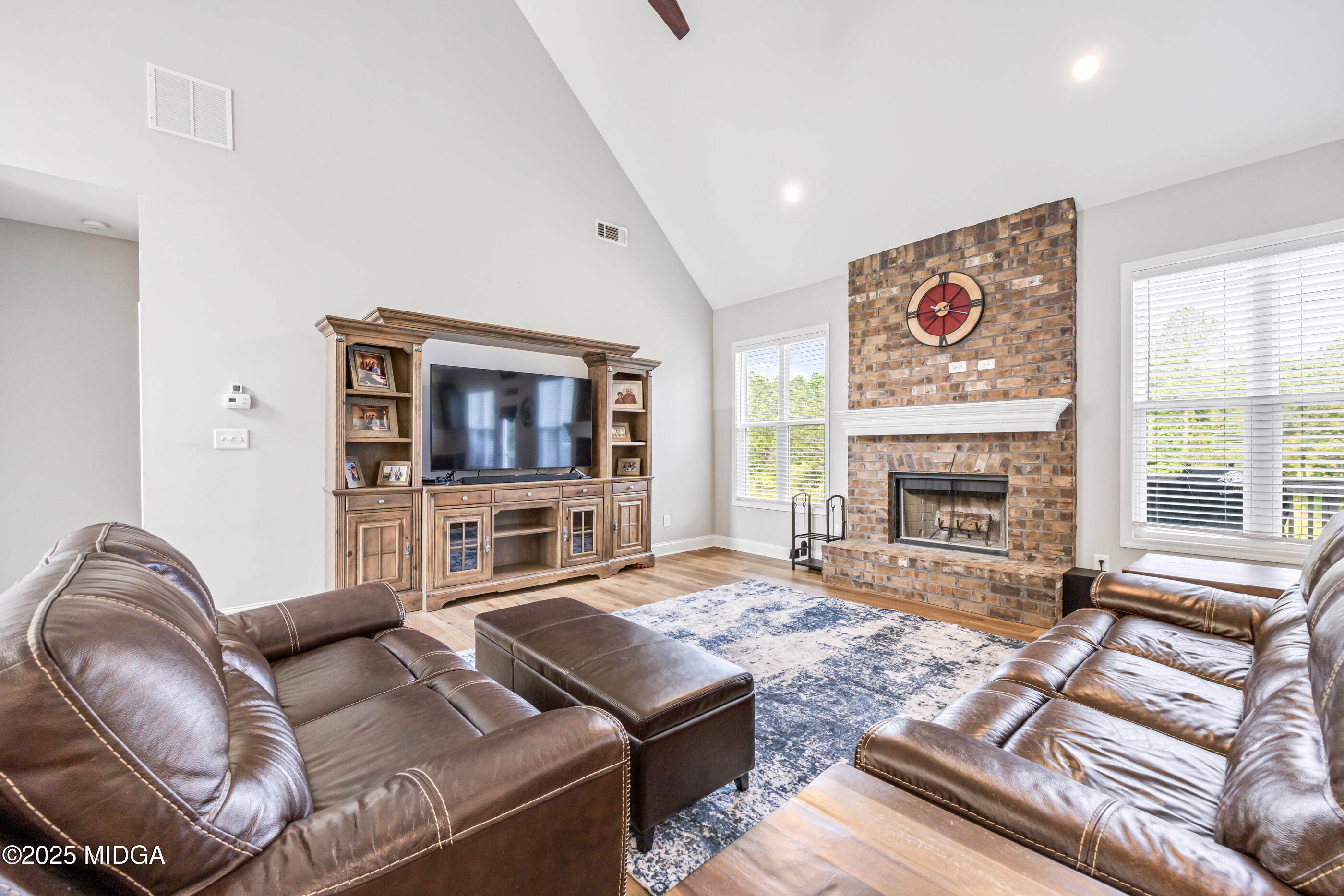 36 River Rapids Drive Forsyth, GA 31029 - Photo 7 of 57 a living room with furniture a flat screen tv and a fireplace
