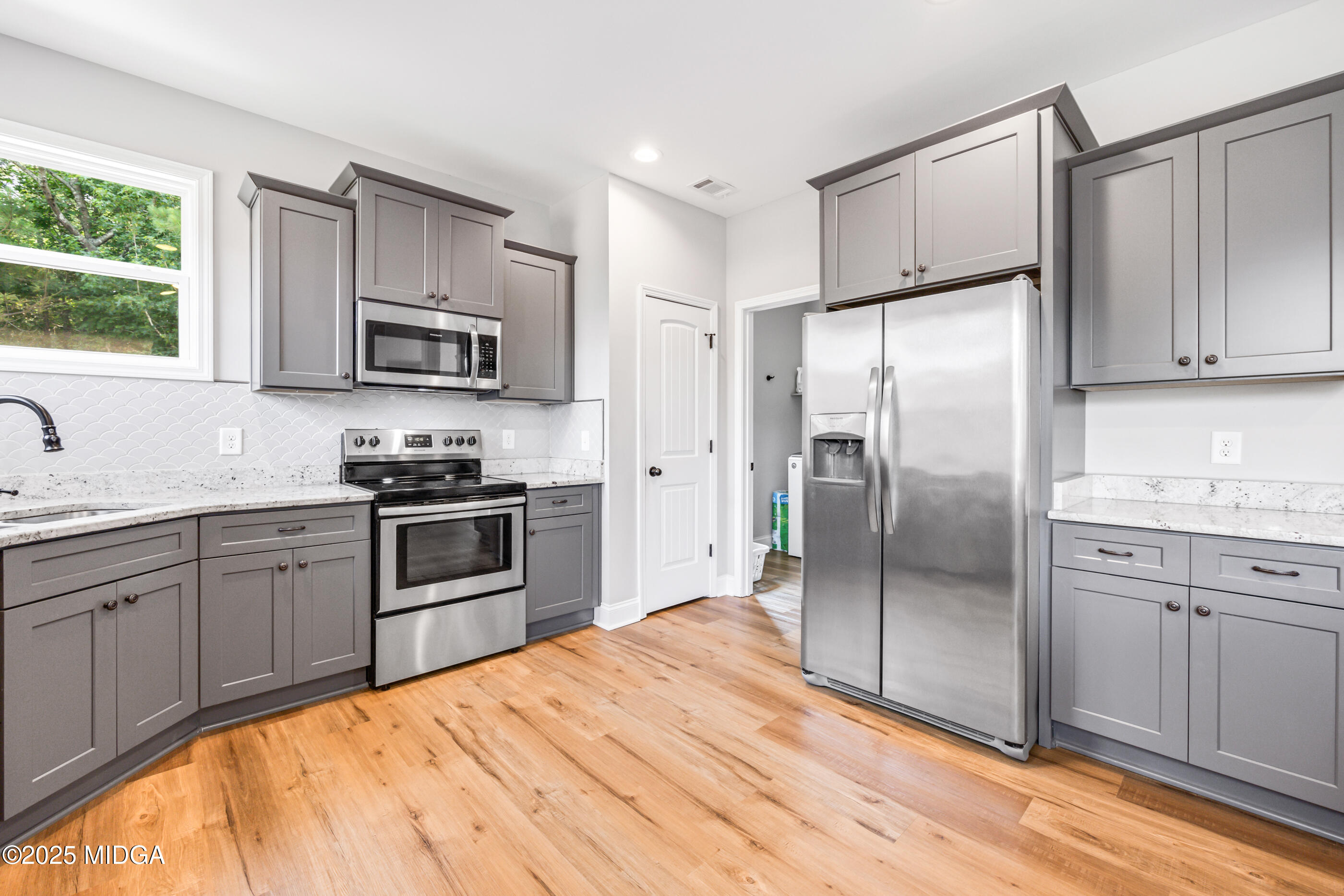 36 River Rapids Drive Forsyth, GA 31029 - Photo 10 of 57 a kitchen with stainless steel appliances granite countertop a refrigerator stove and sink