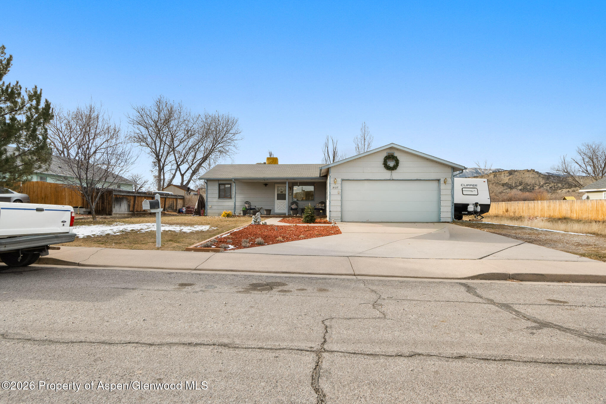 3127 Coal Mine Avenue Rifle, CO 81650 - Photo 2 of 21 a front view of a house with a yard and more windows