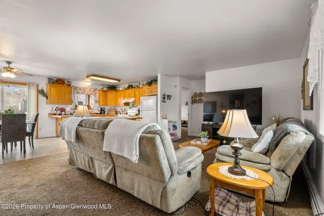 a living room with furniture flowerpot and a table