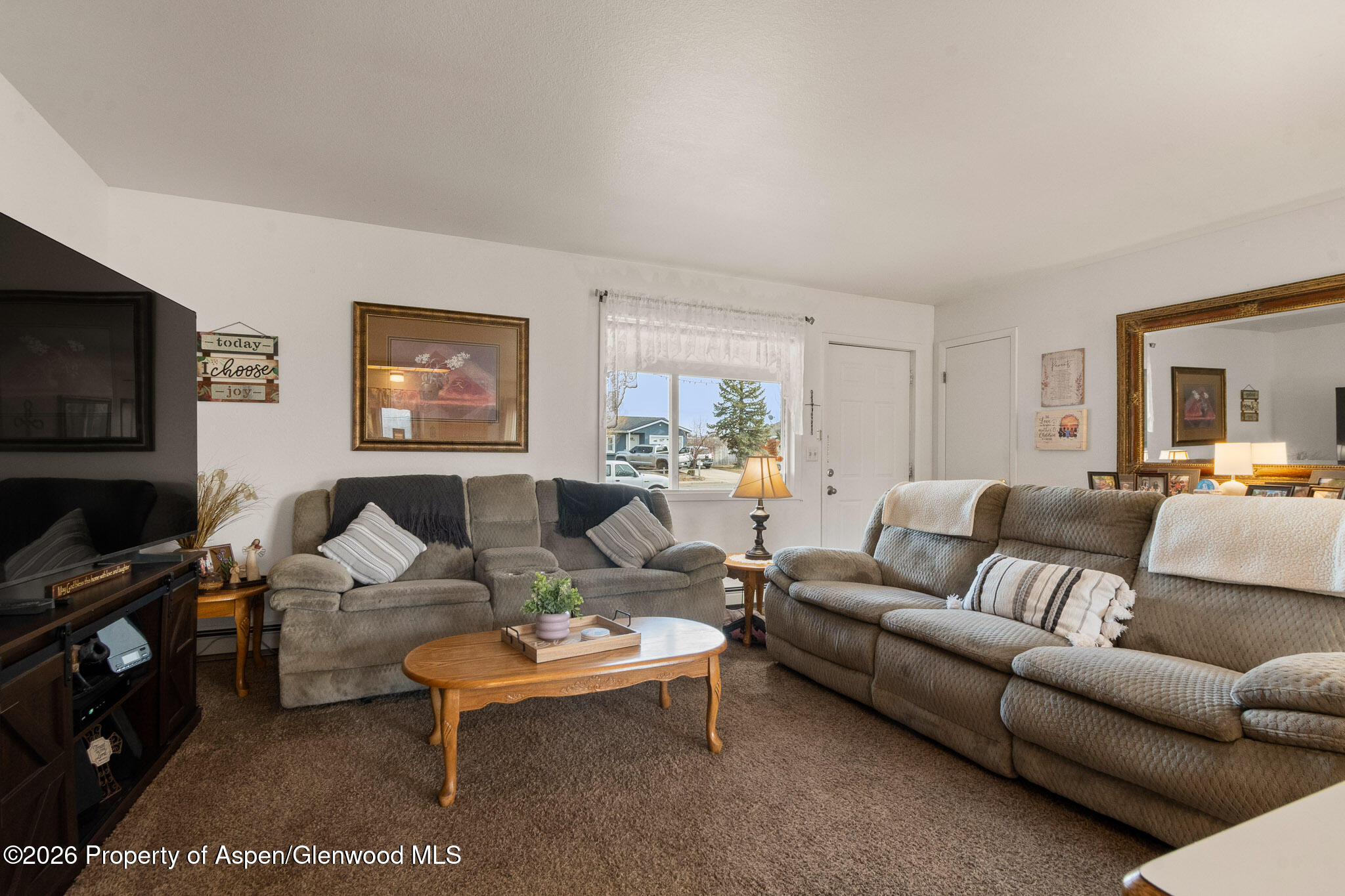 3127 Coal Mine Avenue Rifle, CO 81650 - Photo 6 of 21 a living room with furniture a flat screen tv and a window