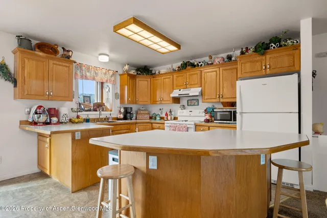 a kitchen with a refrigerator a sink and a stove