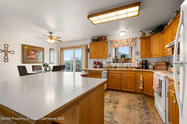 a large white kitchen with a large window