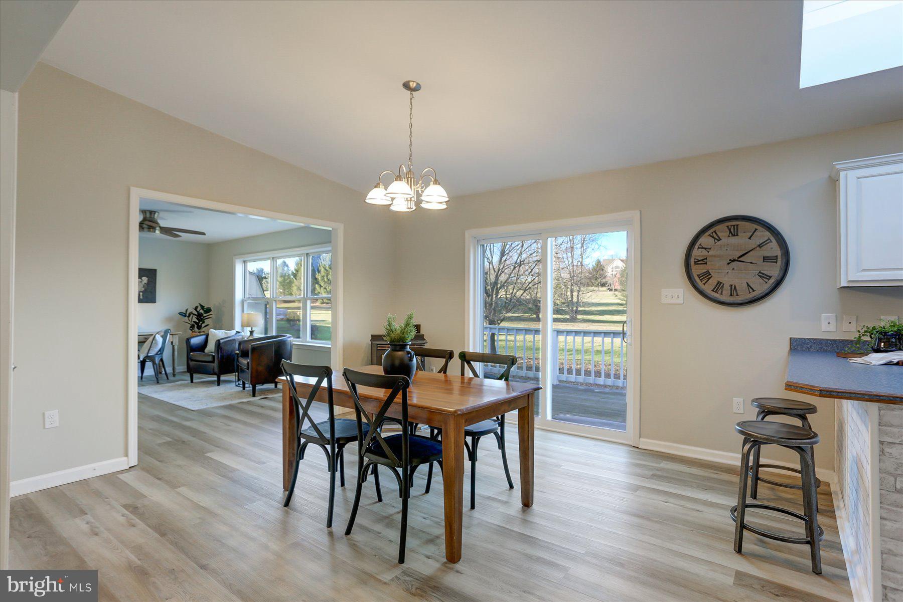 280 Miller Road Halifax, PA 17032 - Photo 8 of 34 a view of a dining room and livingroom with furniture wooden floor a clock and a chandelier