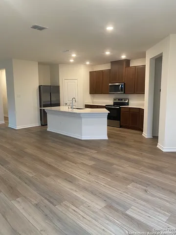 a view of kitchen with cabinets microwave and stove
