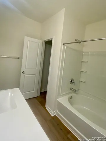 a bathroom with a bathtub and a shower
