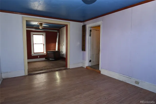 a view of a room with wooden floor
