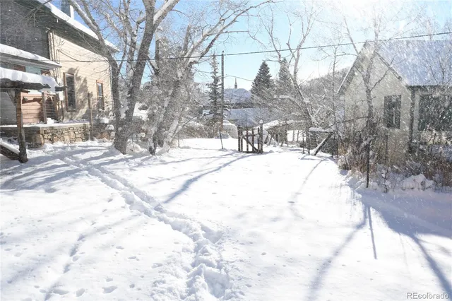 a view of white house with a snow on the road