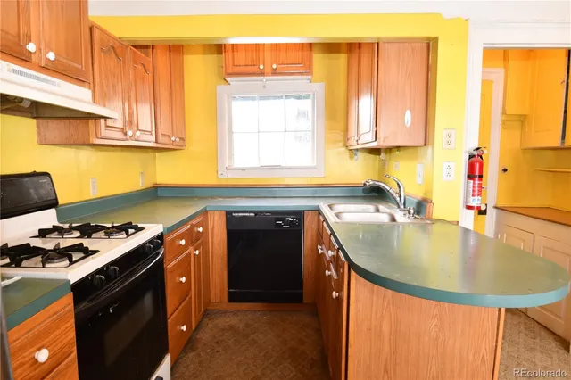 a kitchen with stainless steel appliances granite countertop a refrigerator a sink a stove and a refrigerator