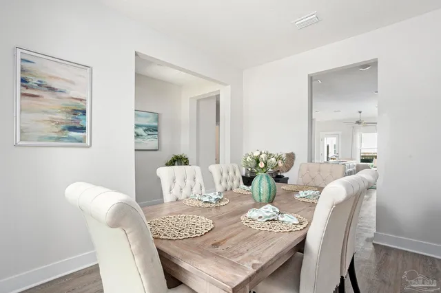 a dining room with furniture and wooden floor