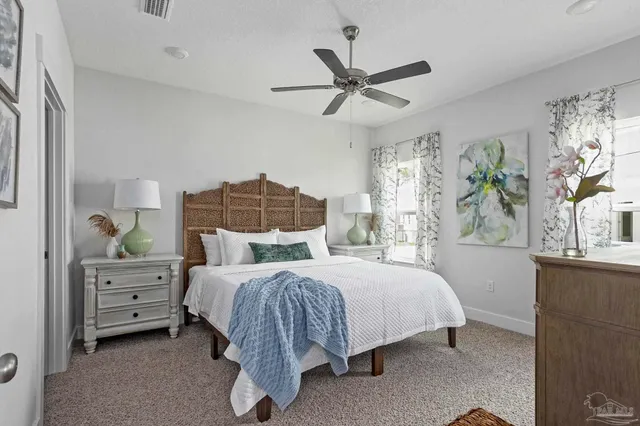 a bedroom with a bed dresser and a window