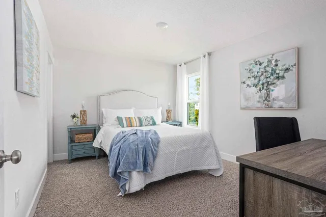 a bedroom with a bed and a table