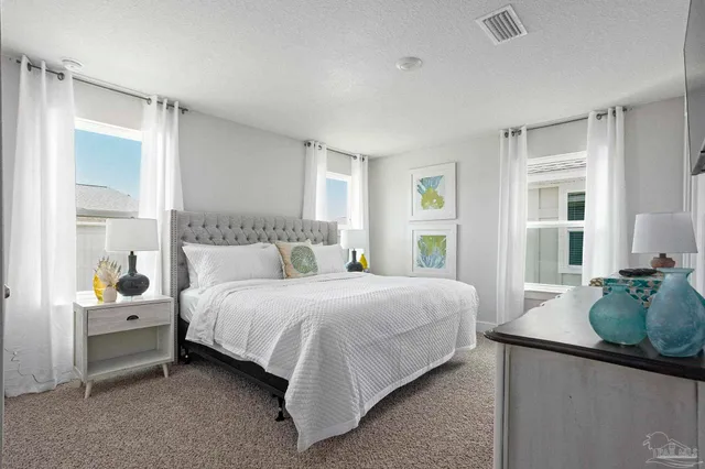 a bedroom with bed and window