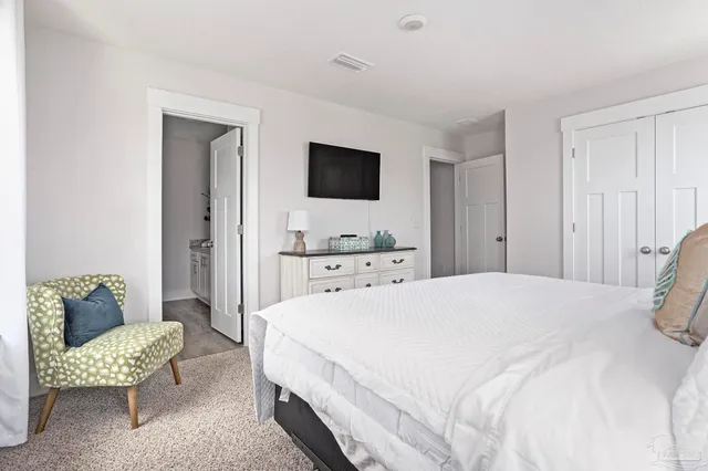 a spacious bedroom with a bed and a couch