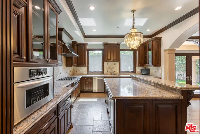 a large kitchen with a stove a sink and a refrigerator