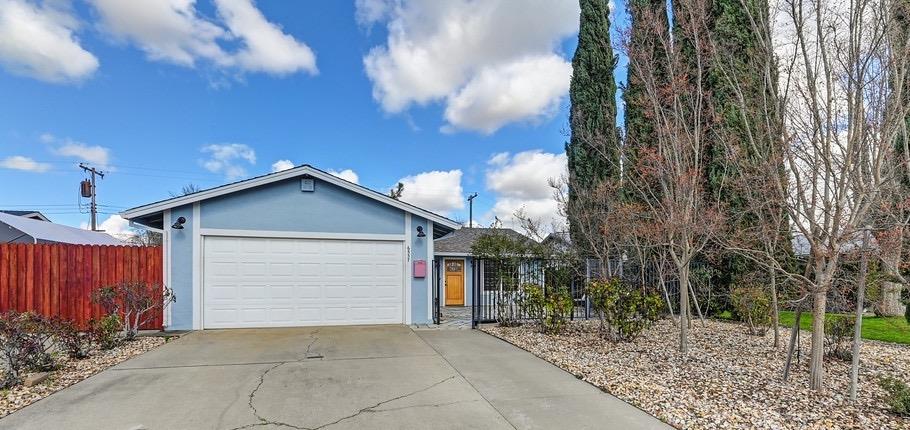 a view of a house with a yard and garage
