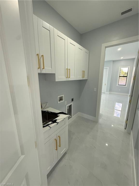 4353 22nd Avenue Northeast Naples, FL 34120 - Photo 13 of 18 a kitchen with white cabinets and white appliances