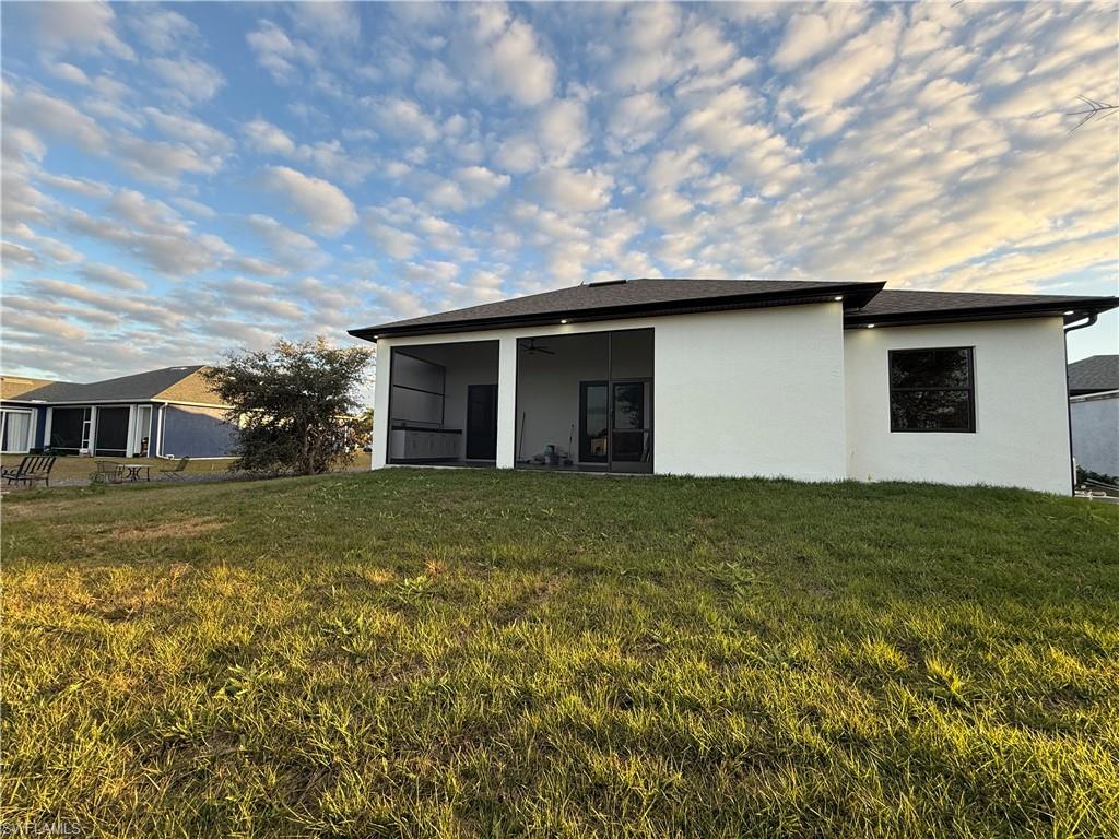 4353 22nd Avenue Northeast Naples, FL 34120 - Photo 5 of 18 a brick house next to a yard with a large tree
