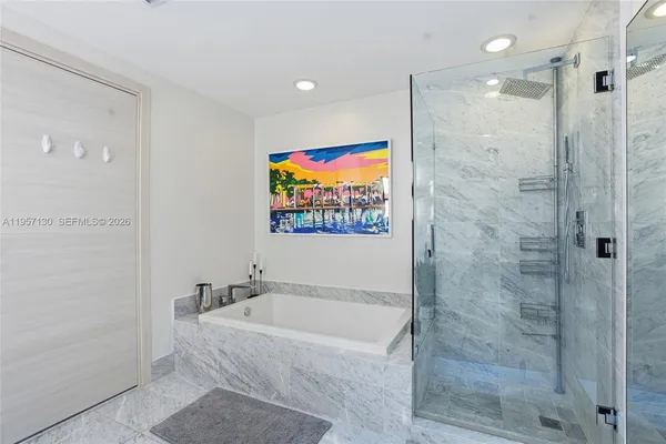 a spacious bathroom with a shower and a bath tub