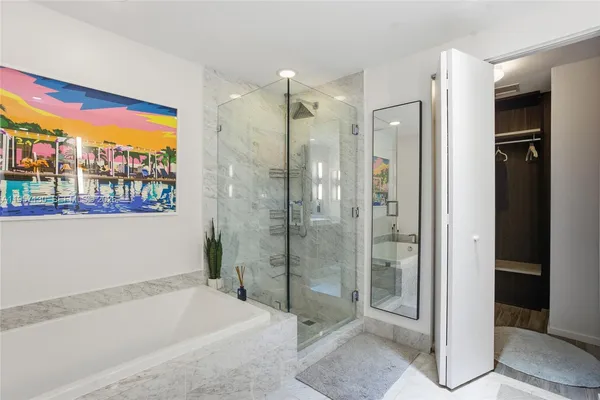 a bathroom with a bathtub and a shower