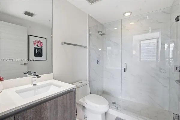 a bathroom with a sink toilet and shower