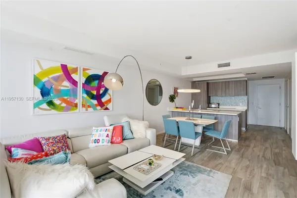 a living room with furniture and a dining table