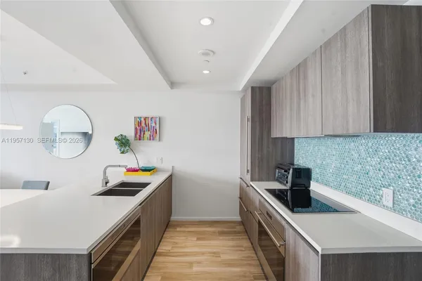 a kitchen with a sink and a stove top oven