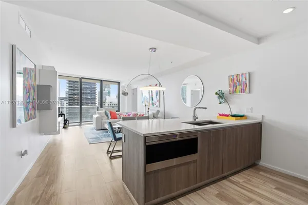 a view of living room with furniture and wooden floor