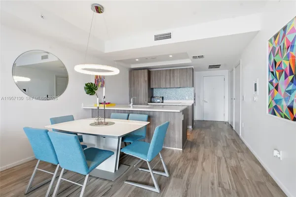 a view of a dining room with furniture and wooden floor