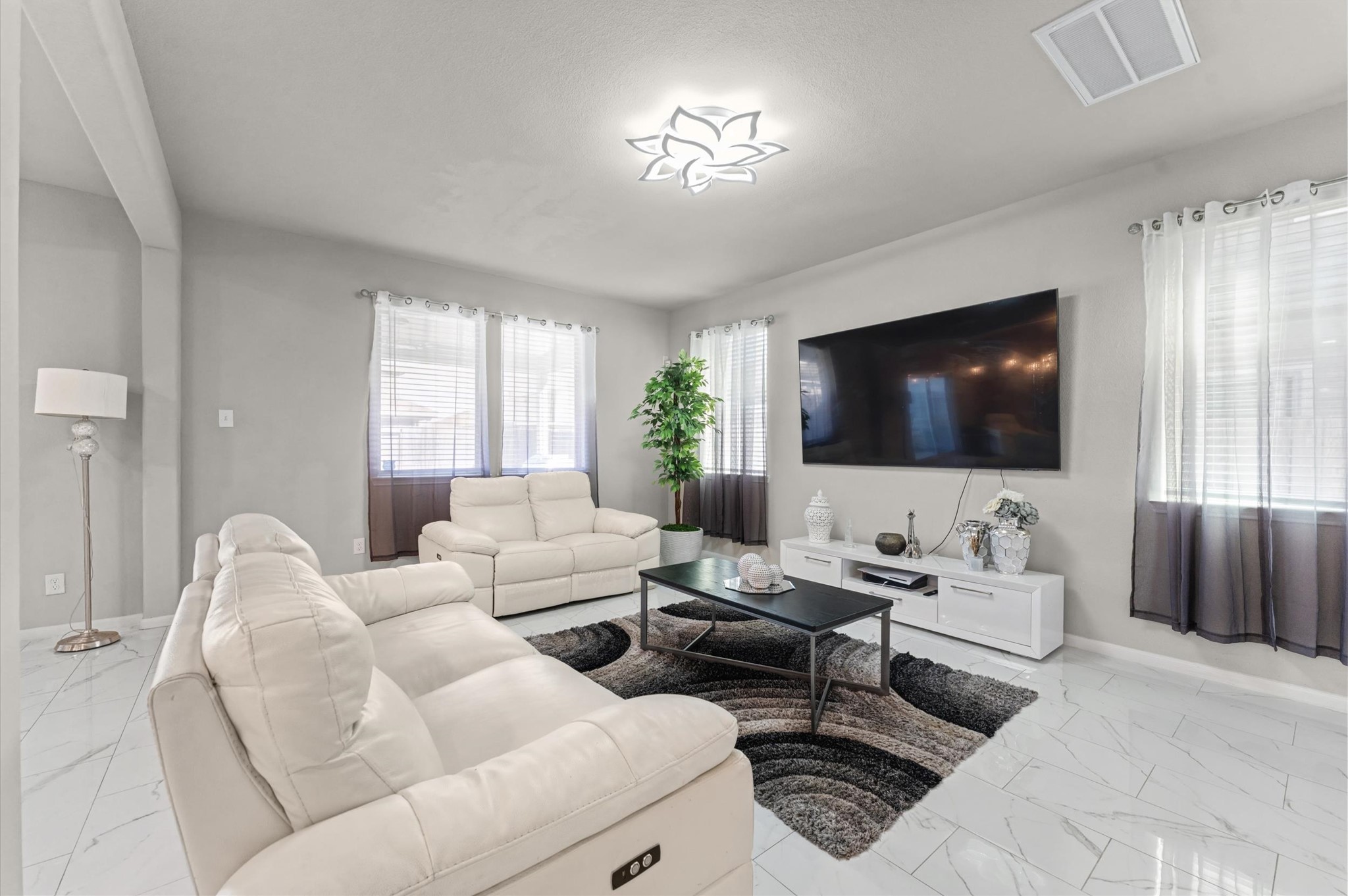21610 Lemon Beebrush Lane Katy, TX 77449 - Photo 11 of 25 a living room with furniture and a flat screen tv