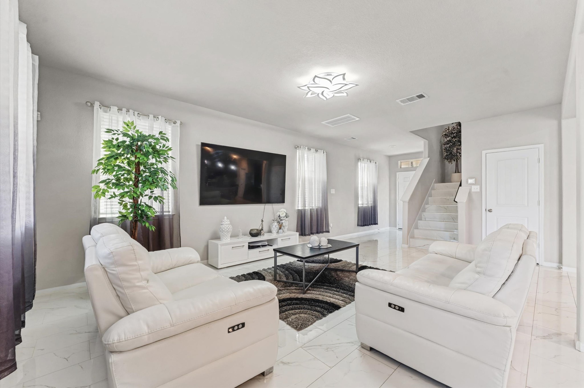 21610 Lemon Beebrush Lane Katy, TX 77449 - Photo 12 of 25 a living room with furniture and a flat screen tv