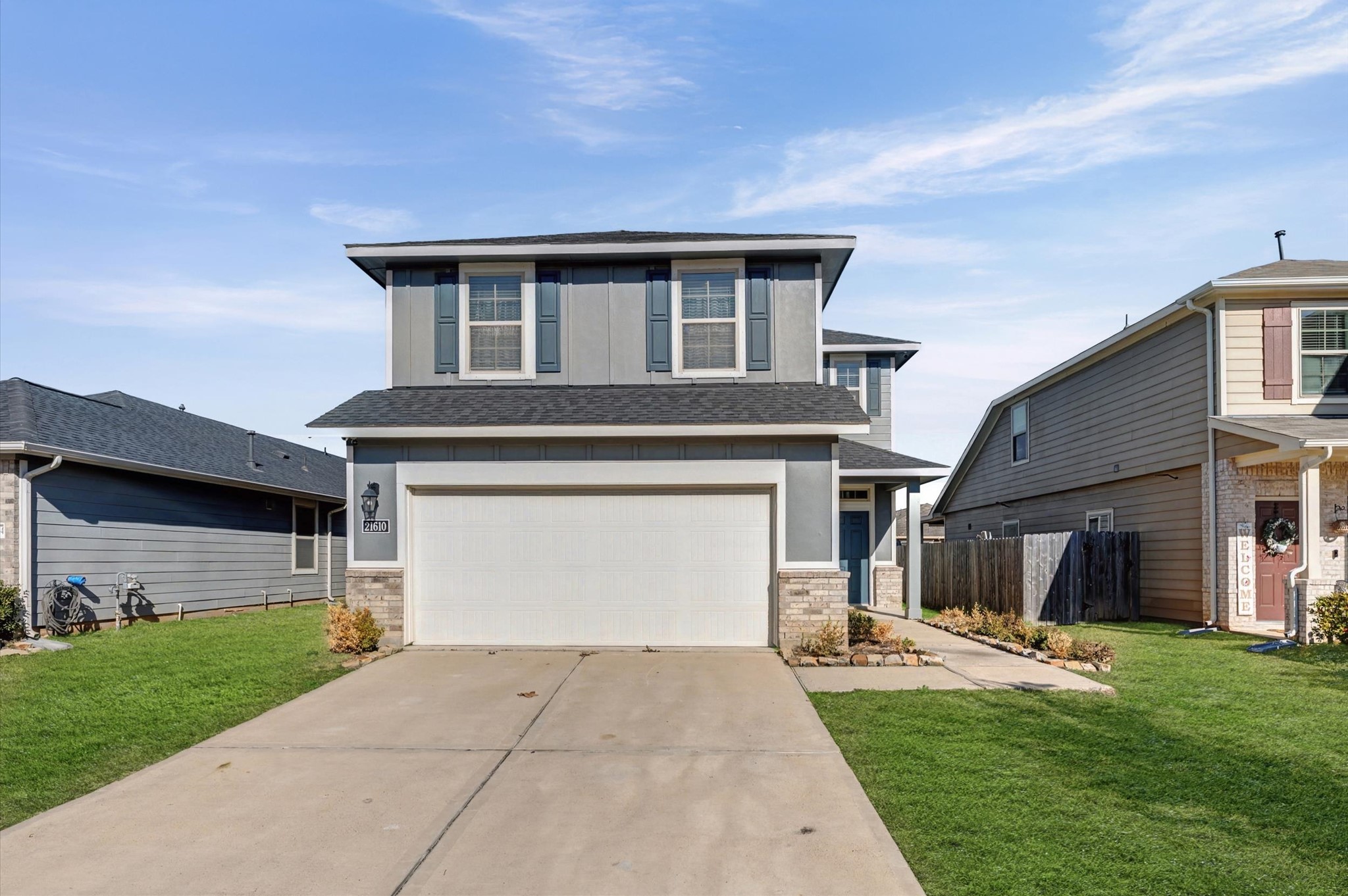 21610 Lemon Beebrush Lane Katy, TX 77449 - Photo 2 of 25 a front view of a house with a yard and garage