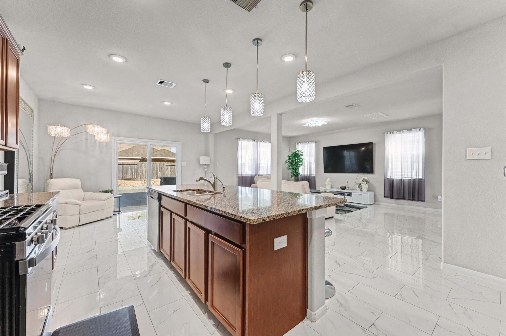 21610 Lemon Beebrush Lane Katy, TX 77449 - Photo 6 of 25 a kitchen with stainless steel appliances granite countertop a stove oven and a refrigerator