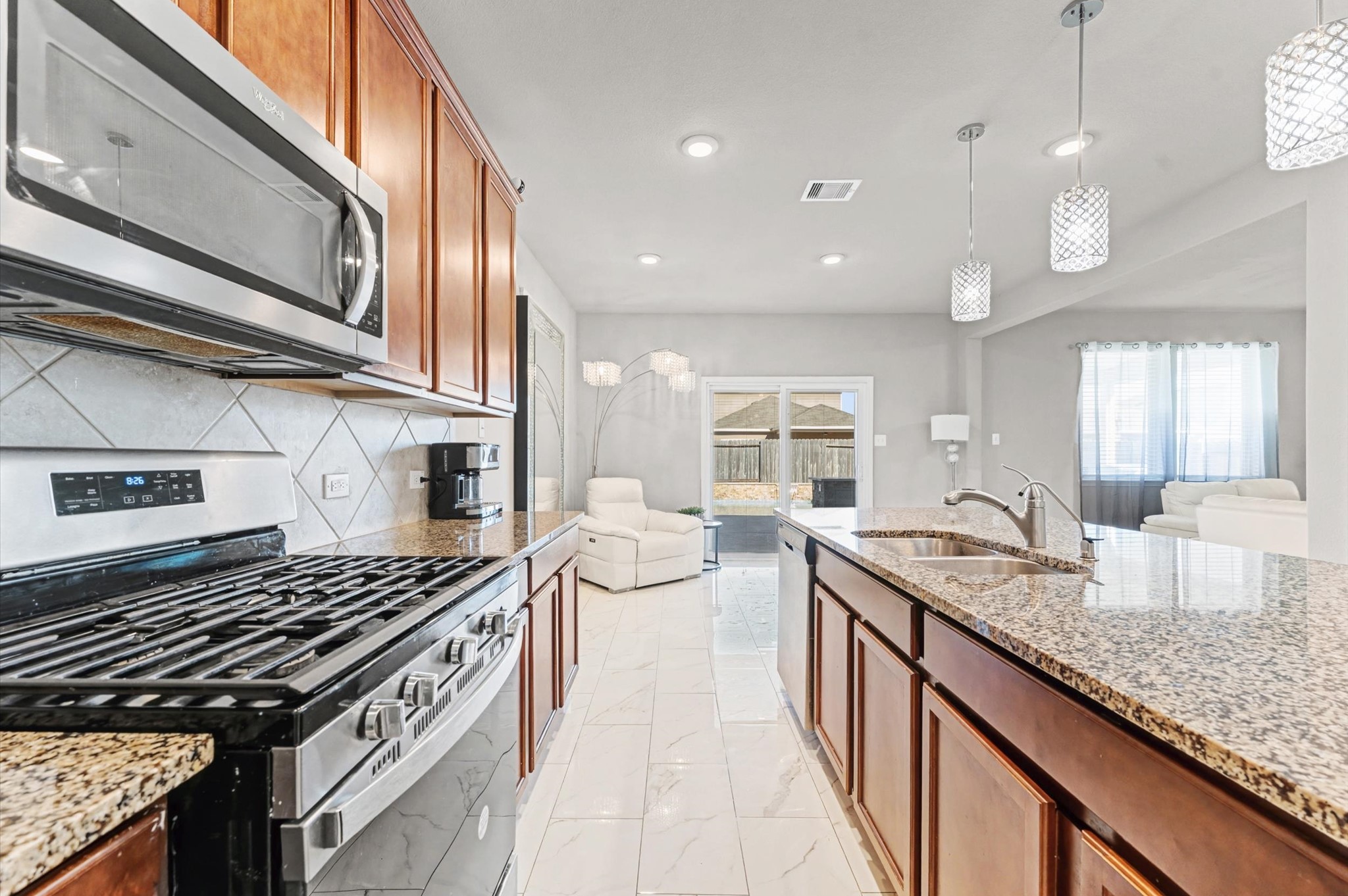 21610 Lemon Beebrush Lane Katy, TX 77449 - Photo 7 of 25 a kitchen with a stove and a sink