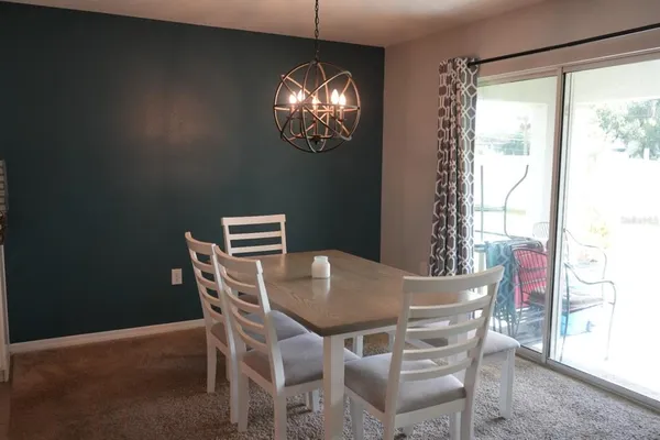 a view of a dining room with furniture window and chandelier