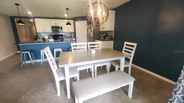 a dining room with furniture and window