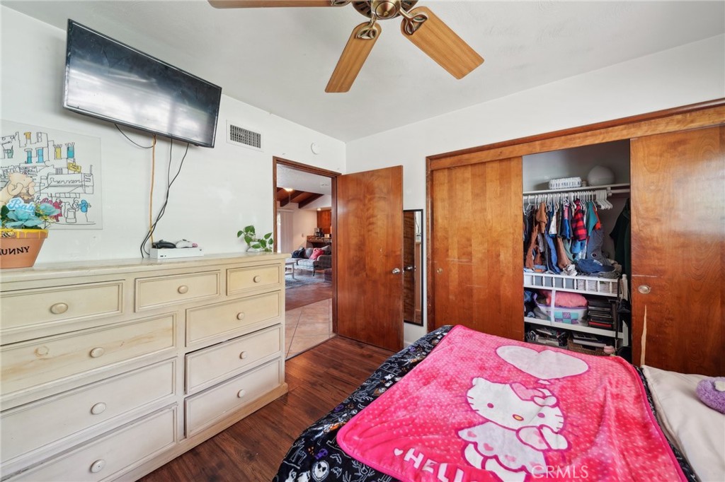 6769 Sunset Circle Riverside, CA 92505 - Photo 26 of 54 a bedroom with a bed and a flat tv screen on dresser