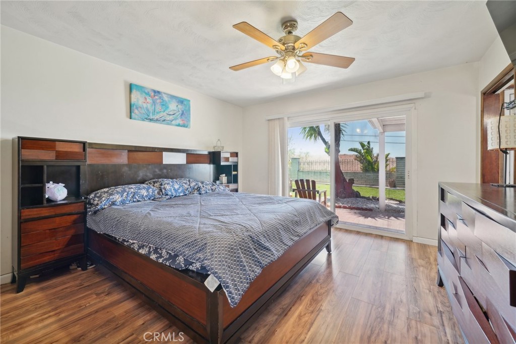 6769 Sunset Circle Riverside, CA 92505 - Photo 30 of 54 a bedroom with a large bed a chandelier and dresser