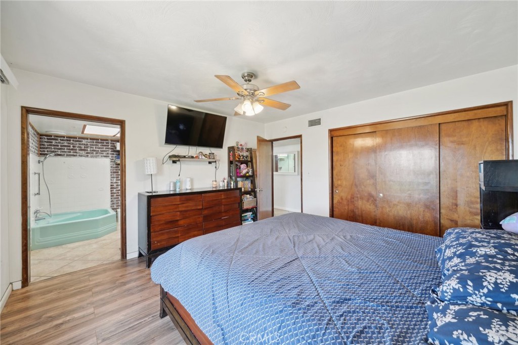 6769 Sunset Circle Riverside, CA 92505 - Photo 31 of 54 a bed room with a bed a flat screen tv and a dresser