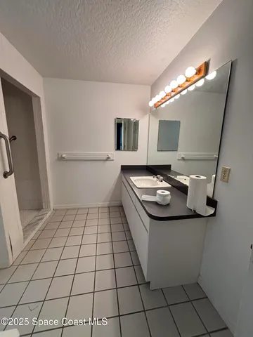 a bathroom with a sink toilet and mirror