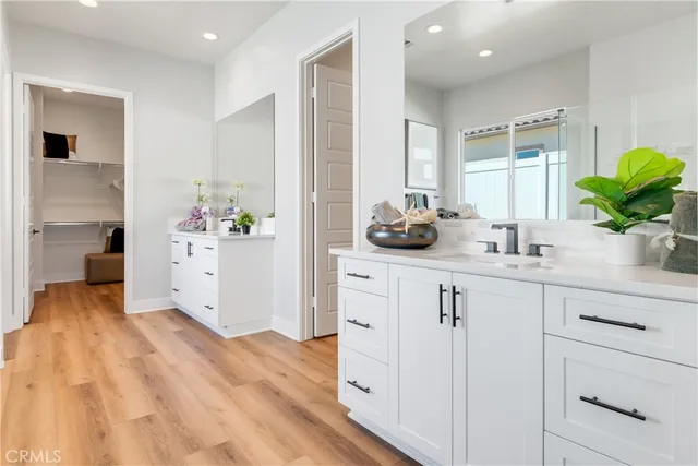 a spacious bathroom with a tub shower and a sink