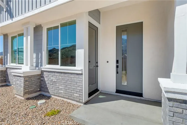 a living room with furniture wooden floor and a large window