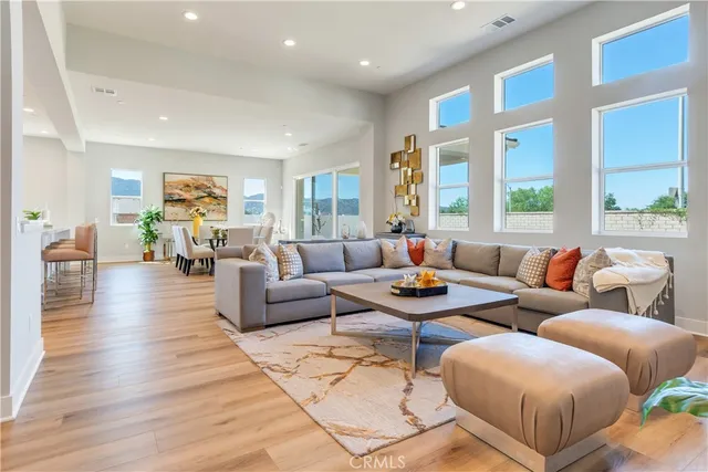 a living room with furniture and kitchen view