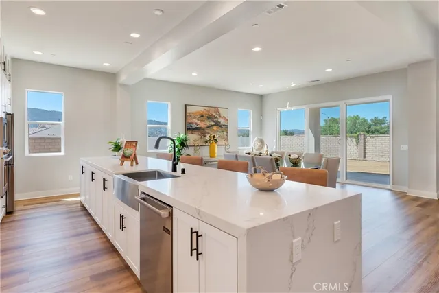a large white kitchen with stainless steel appliances granite countertop lots of counter top space