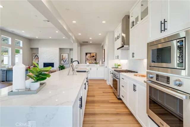 a kitchen with a stove and a white cabinets