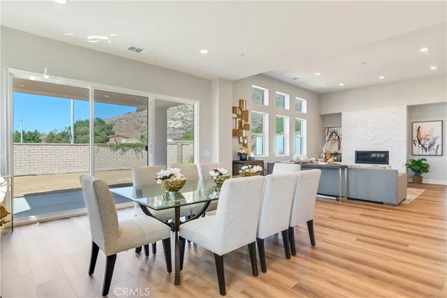 a view of a hallway with wooden floor and a bathroom