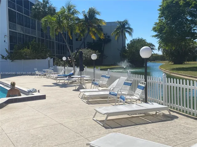 a view of a patio with swimming pool table and chairs