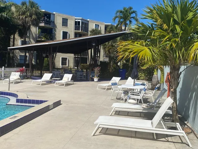 a view of a patio with a table and chairs
